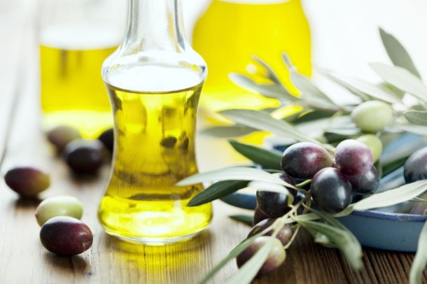 olive oil on table with olives