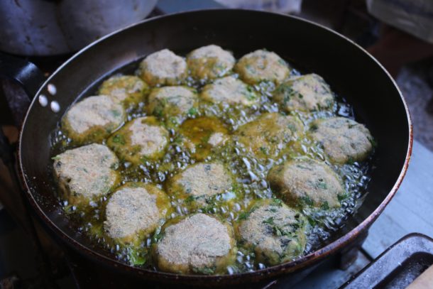 Mediterranean Diet: Zucchini Fritters frying in olive oil