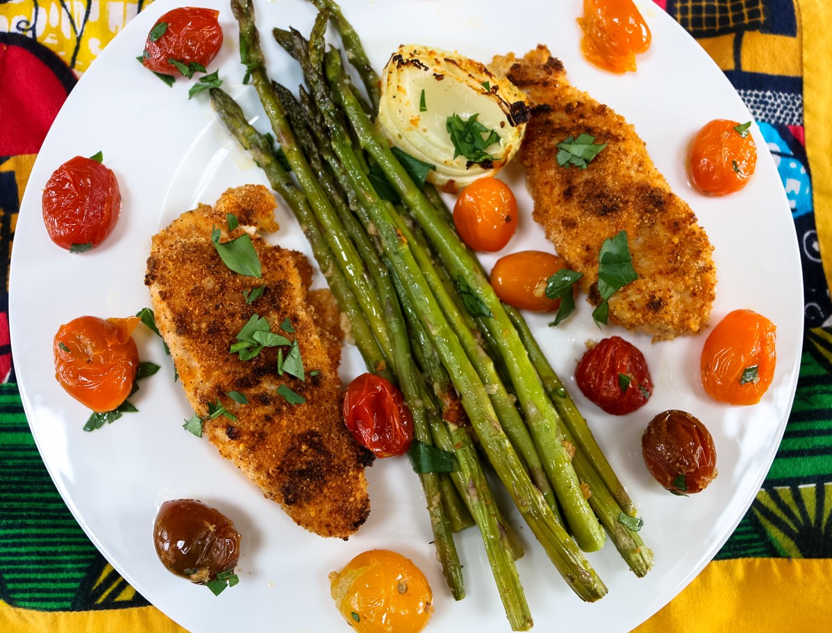 Mediterranean Fried Chicken with Cherry Tomatoes and Asparagus on colorful plate Mediterranean Fried Chicken with Cherry Tomatoes and Asparagus