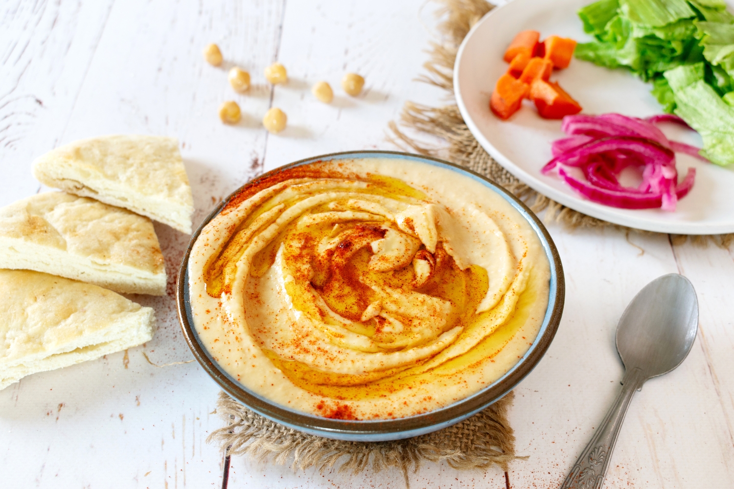 Restaurant-style creamy hummus with olive oil and paprika