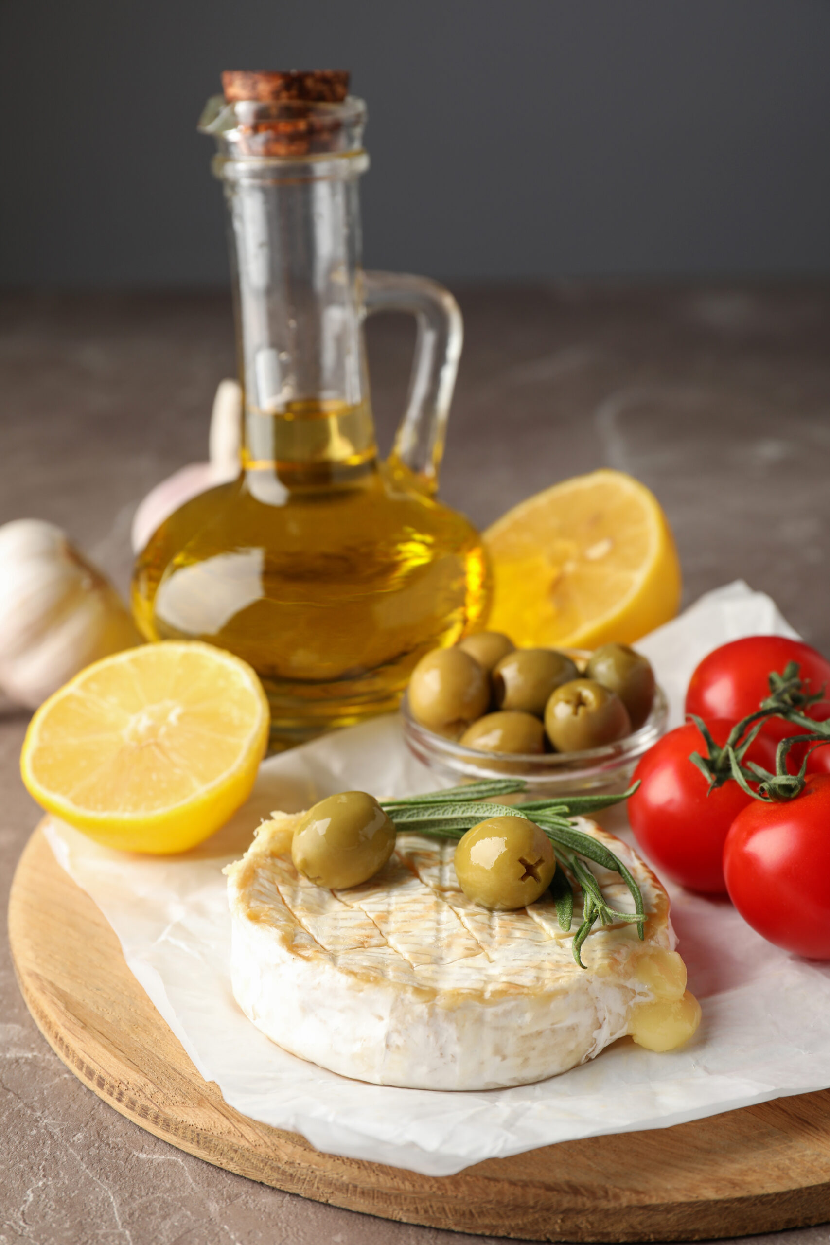 Concept of tasty food with grilled camembert on gray texture table.